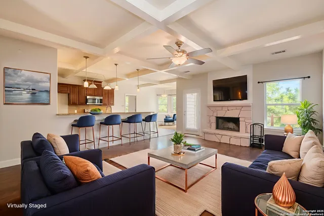 a living room with furniture a fireplace and a flat screen tv