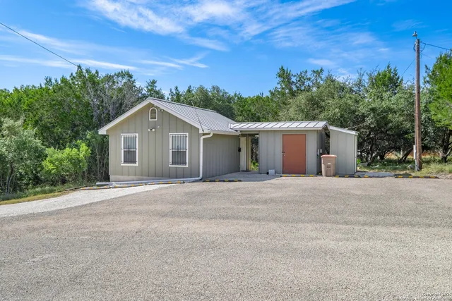 a view of a backyard with a wooden fence