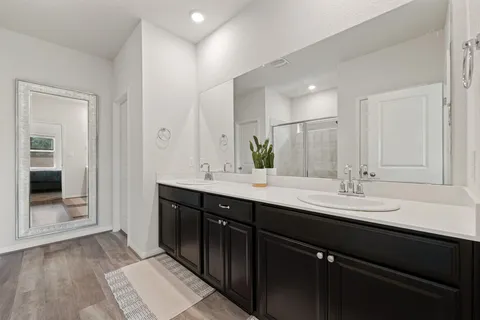 a bathroom with a double vanity sink and a mirror
