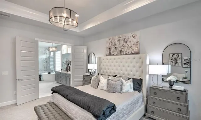 a bedroom with a bed and dresser with mirror