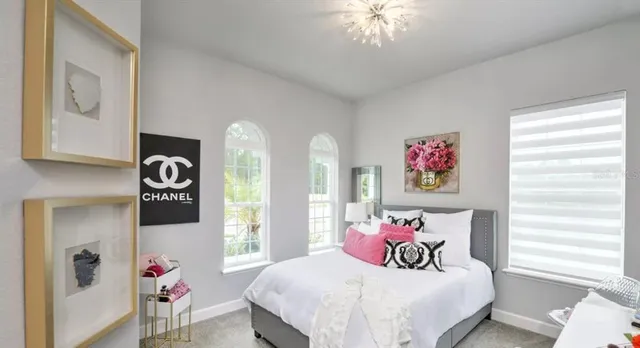 a bedroom with a bed and a chandelier