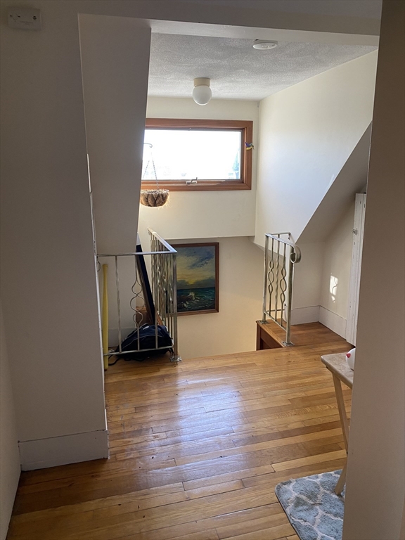213 Holland Street, Unit R Somerville, MA 02144 - Photo 11 of 23 a view of empty room with wooden floor