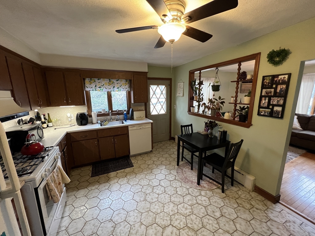 213 Holland Street, Unit R Somerville, MA 02144 - Photo 4 of 23 a living room with furniture a flat screen tv and a window