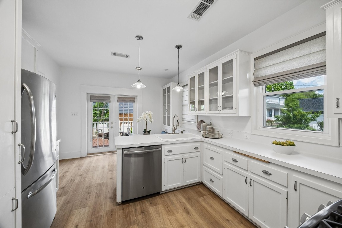 623 Pecore Street Houston, TX 77009 - Photo 8 of 19 a kitchen with white cabinets and wooden floors