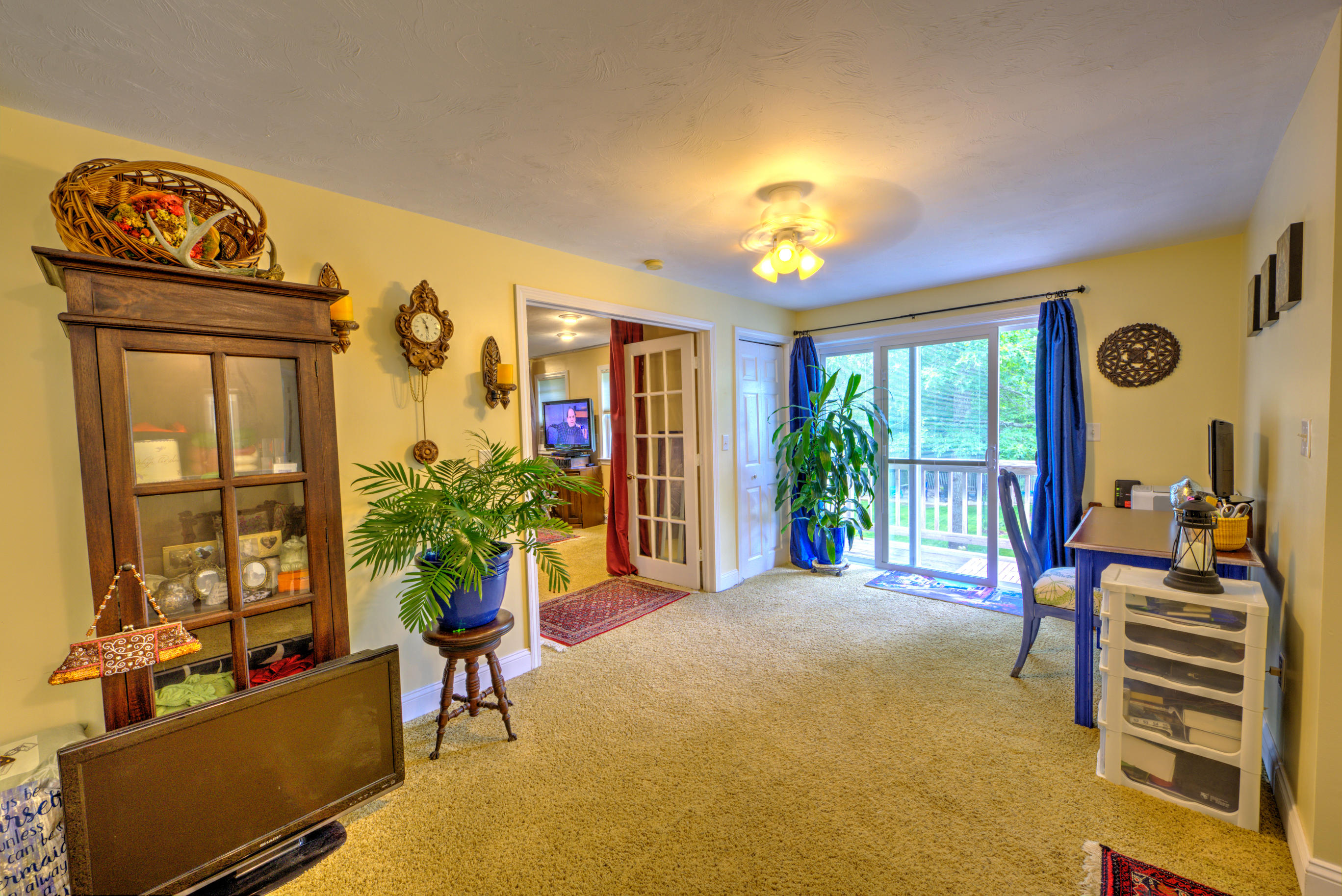 1 Cotuit Road Sandwich, MA 02563 - Photo 18 of 33 a living room with furniture a chandelier and a flat screen tv