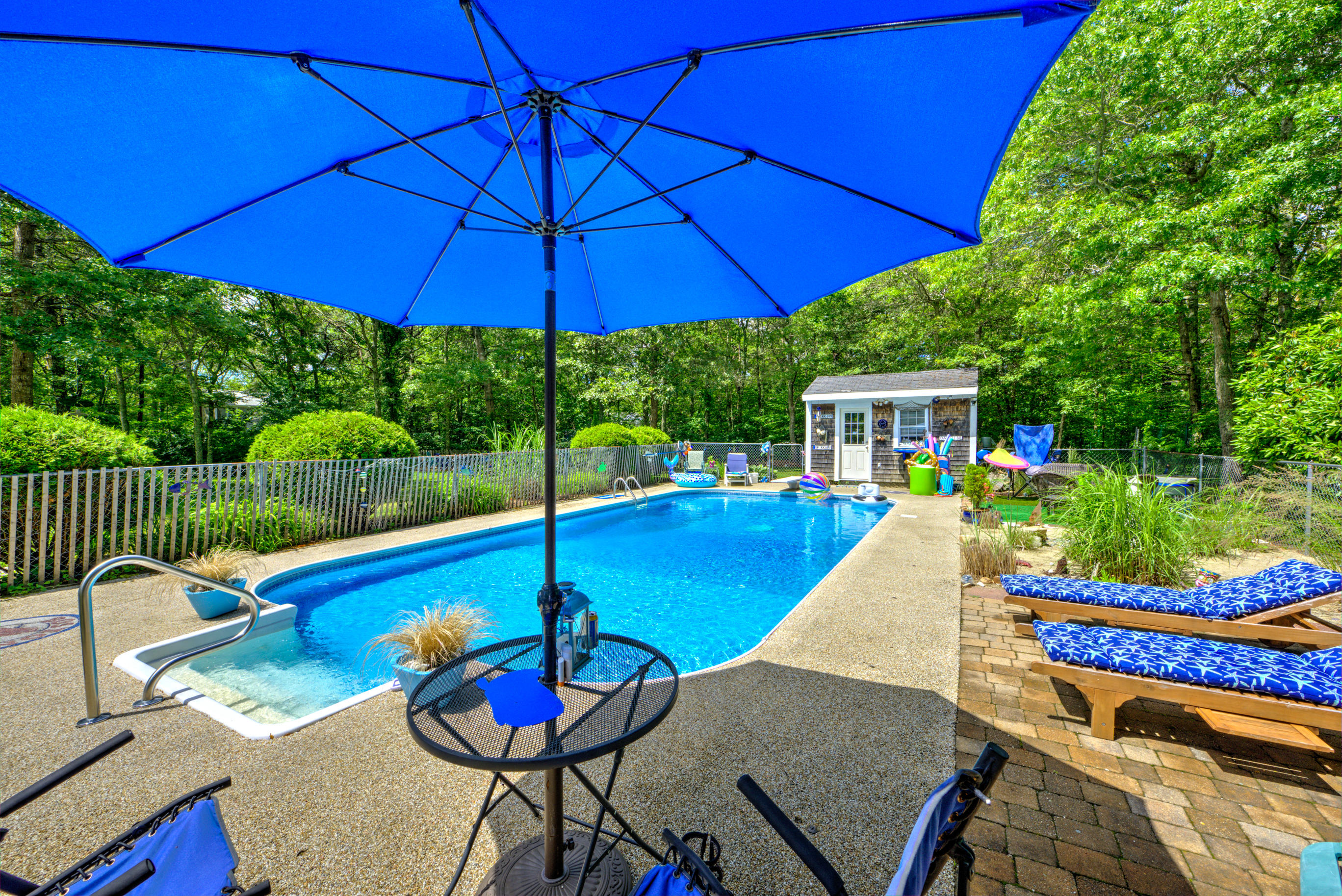 1 Cotuit Road Sandwich, MA 02563 - Photo 24 of 33 a view of a patio with a table and chairs under an umbrella
