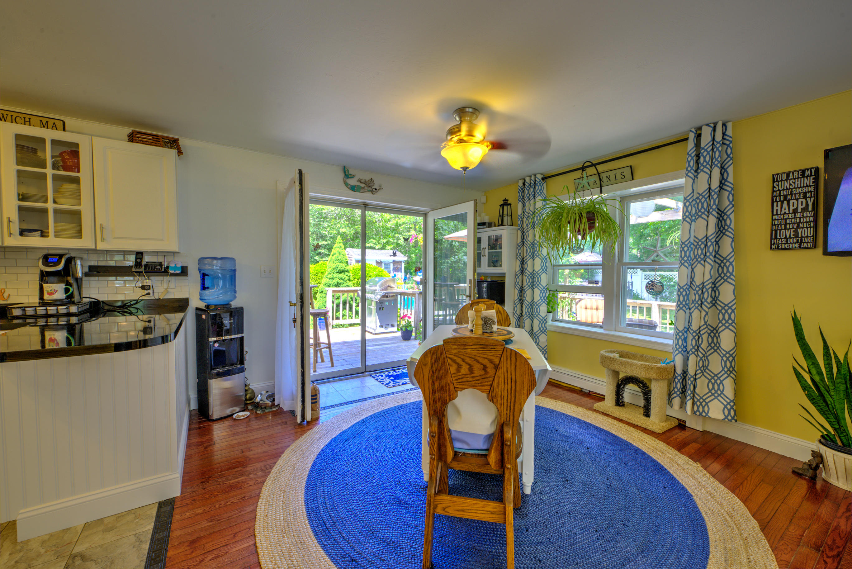 1 Cotuit Road Sandwich, MA 02563 - Photo 8 of 33 a living room with furniture dining table wooden floor and a large window