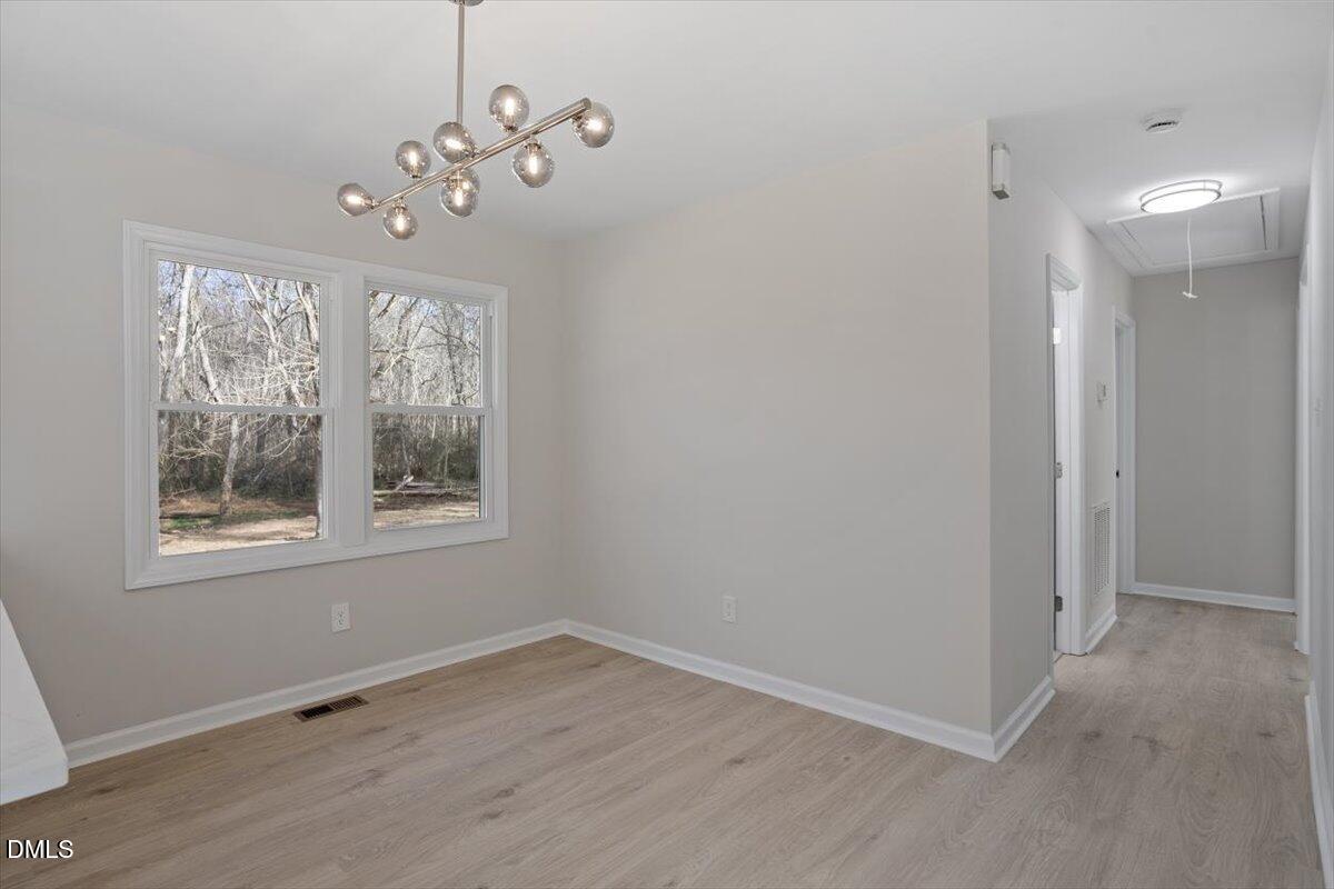 5326 Salem Church Road Graham, NC 27253 - Photo 12 of 20 an empty room with wooden floor and windows