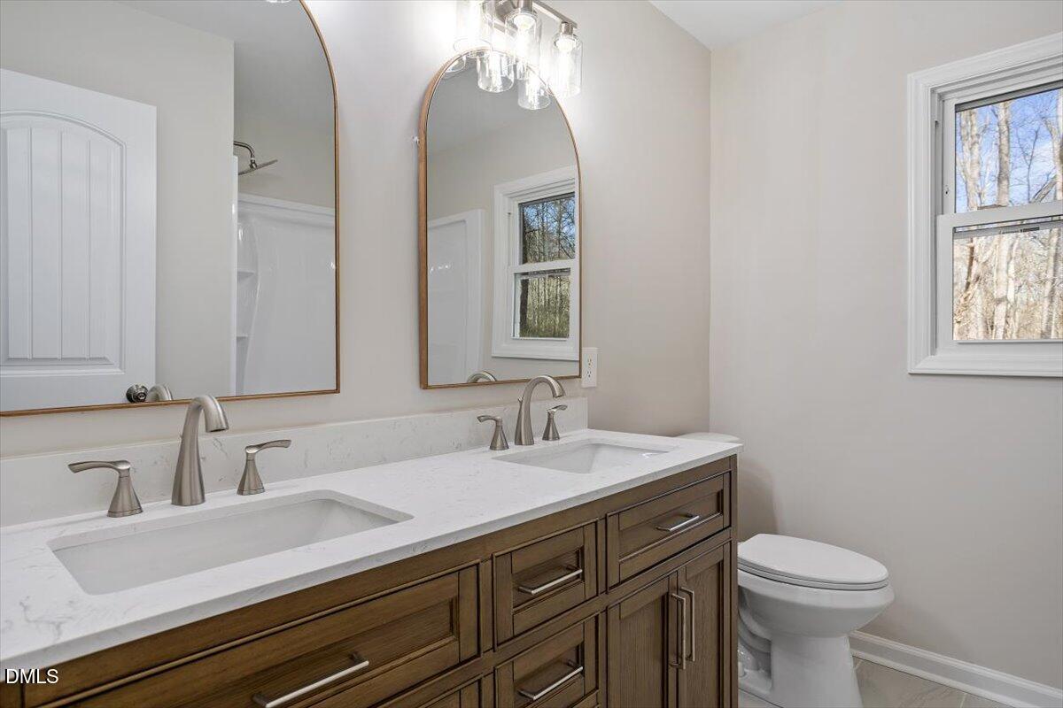 5326 Salem Church Road Graham, NC 27253 - Photo 16 of 20 a bathroom with a sink a toilet and mirror