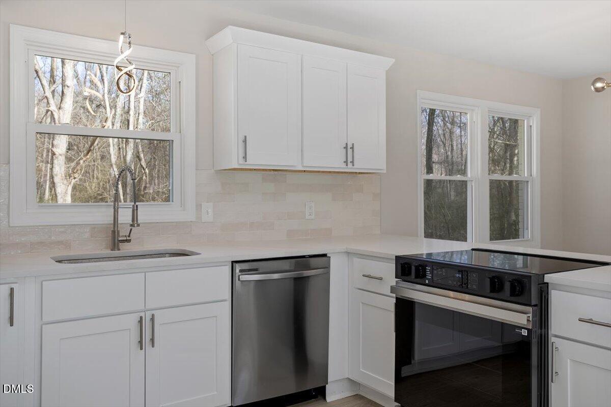 5326 Salem Church Road Graham, NC 27253 - Photo 4 of 20 a kitchen with granite countertop white cabinets and white appliances