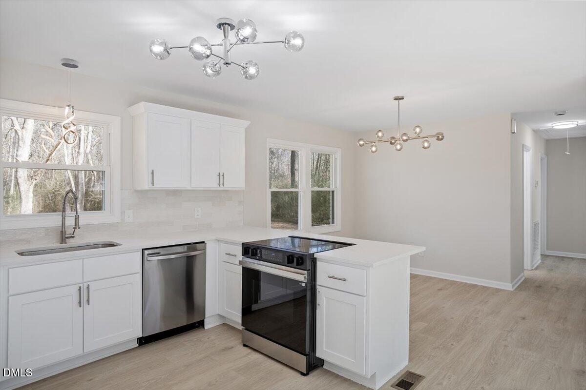 5326 Salem Church Road Graham, NC 27253 - Photo 6 of 20 a kitchen that has a sink a stove and cabinets