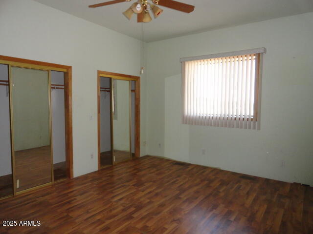 8279 East Larson Road Hereford, AZ 85615 - Photo 19 of 22 a view of an empty room with wooden floor and a window