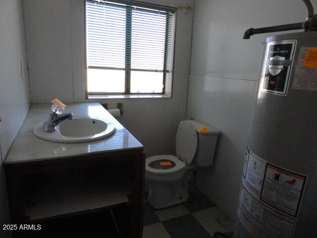 8279 East Larson Road Hereford, AZ 85615 - Photo 20 of 22 a bathroom with a sink toilet and window