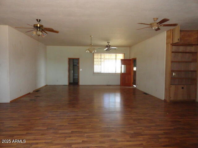8279 East Larson Road Hereford, AZ 85615 - Photo 8 of 22 a view of empty room with wooden floor and fan