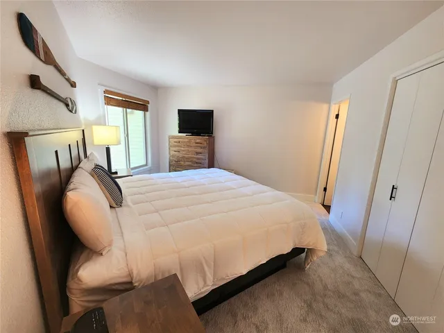 a bed sitting in a bedroom next to a window