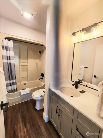 a bathroom with a double vanity sink and a mirror