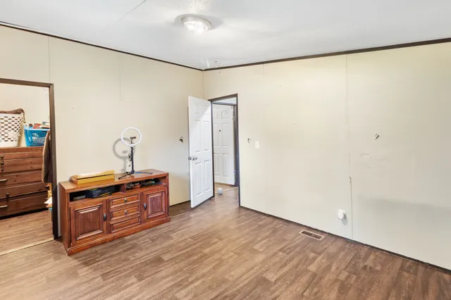 a view of a room with wooden floor