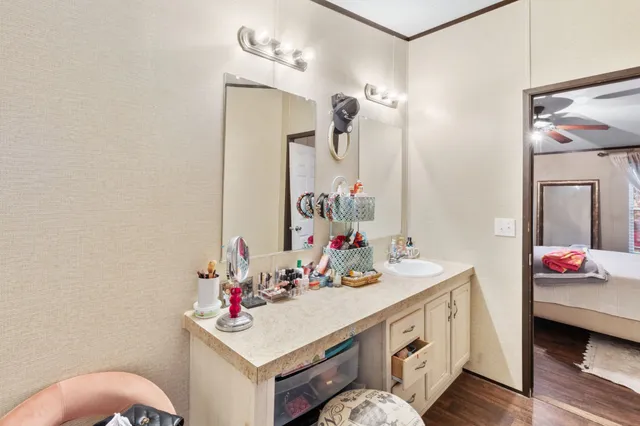 a bathroom with a sink vanity and a mirror