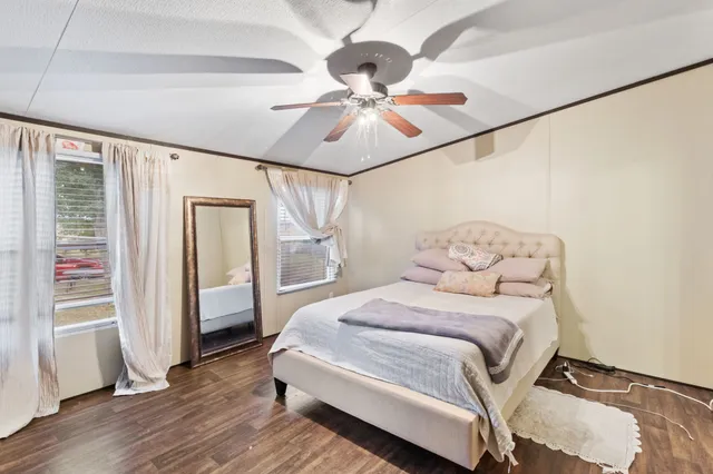 a bedroom with a bed and wooden floor