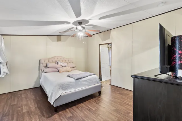 a bedroom with a bed and a flat screen tv