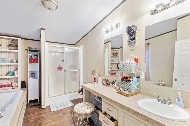 a bathroom with a sink vanity granite tub shower and toilet