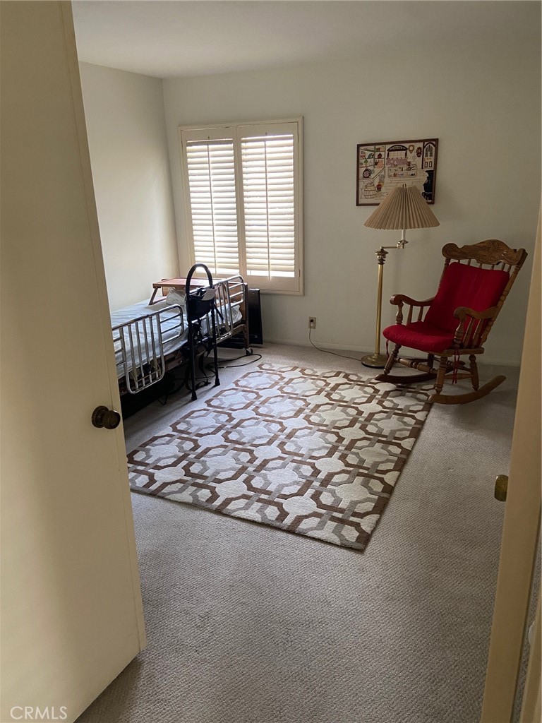 22332 Fallen Leaf Road Lake Forest, CA 92630 - Photo 11 of 33 a bed sitting in a bedroom next to a window with chair