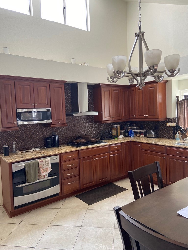 22332 Fallen Leaf Road Lake Forest, CA 92630 - Photo 14 of 33 a kitchen with a stove a sink a microwave and cabinets