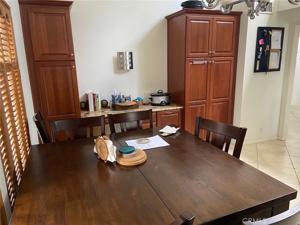 22332 Fallen Leaf Road Lake Forest, CA 92630 - Photo 16 of 33 a view of a dining room with furniture wooden floor and carpet