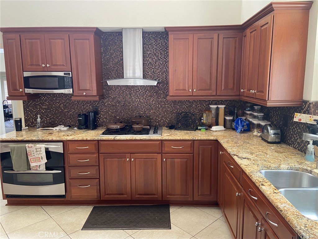 22332 Fallen Leaf Road Lake Forest, CA 92630 - Photo 17 of 33 a kitchen with stainless steel appliances granite countertop a sink stove and cabinets