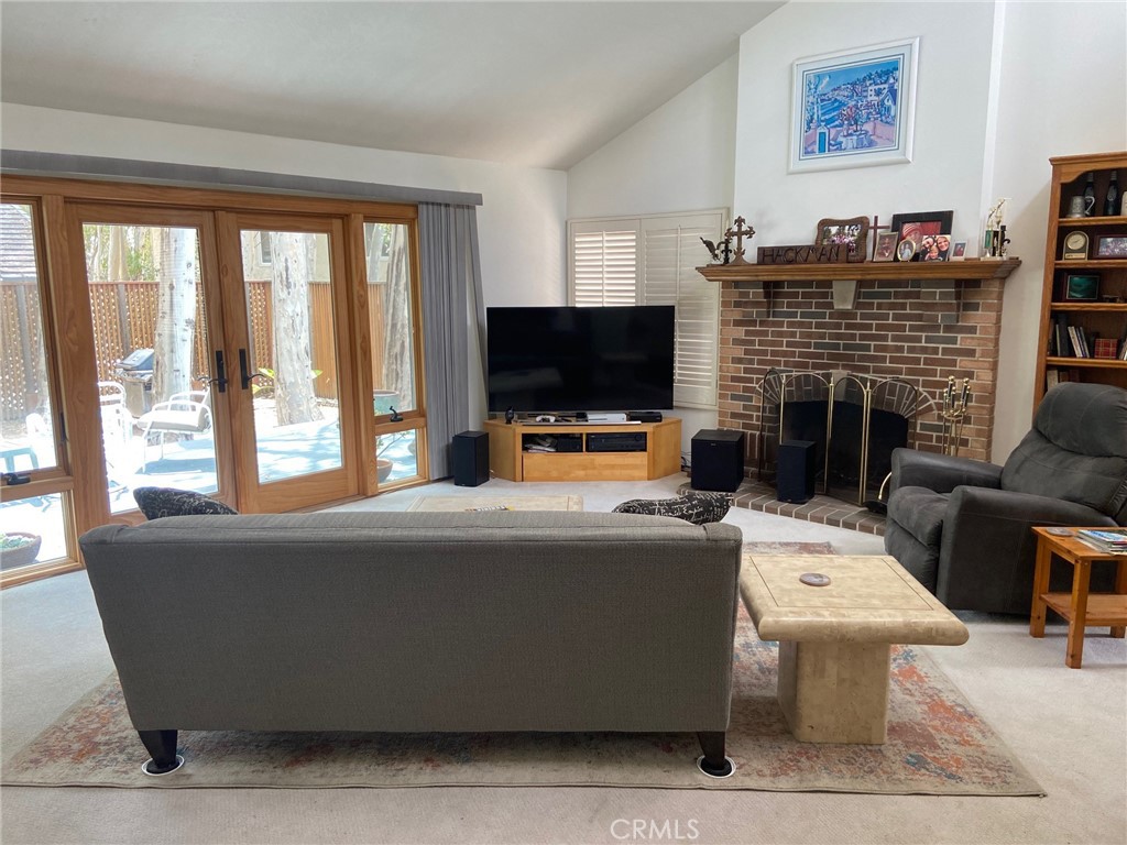 22332 Fallen Leaf Road Lake Forest, CA 92630 - Photo 10 of 33 a living room with fireplace furniture and a flat screen tv
