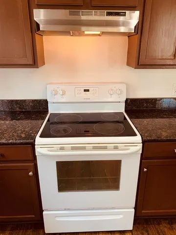 a stove top oven sitting inside of a kitchen