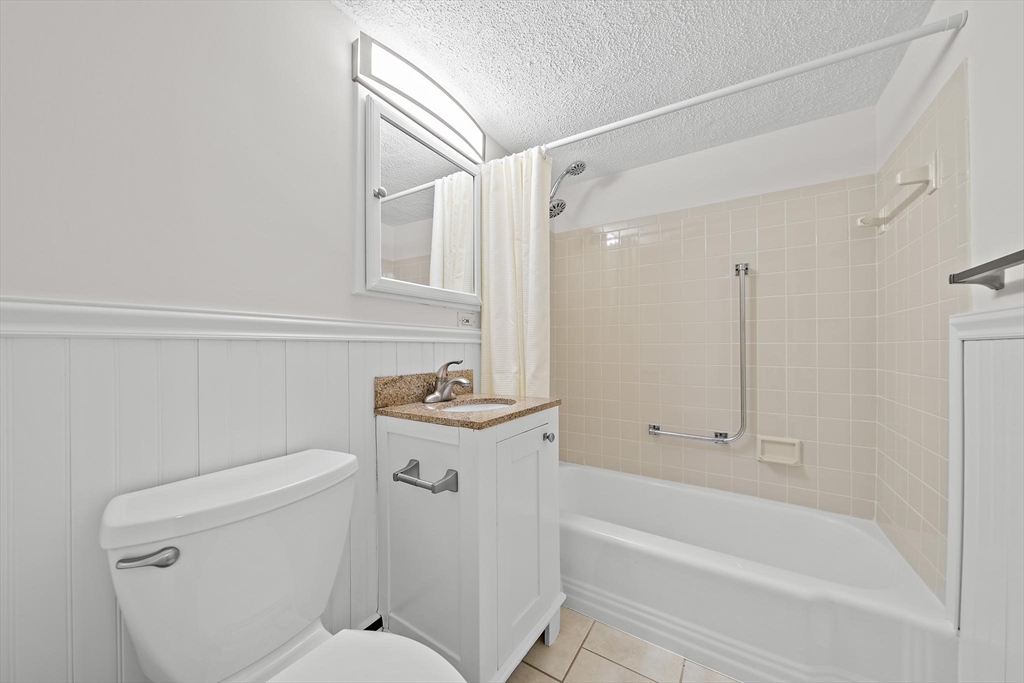 50 Green Street, Unit 108 Brookline, MA 02446 - Photo 13 of 22 a bathroom with a sink a toilet and shower