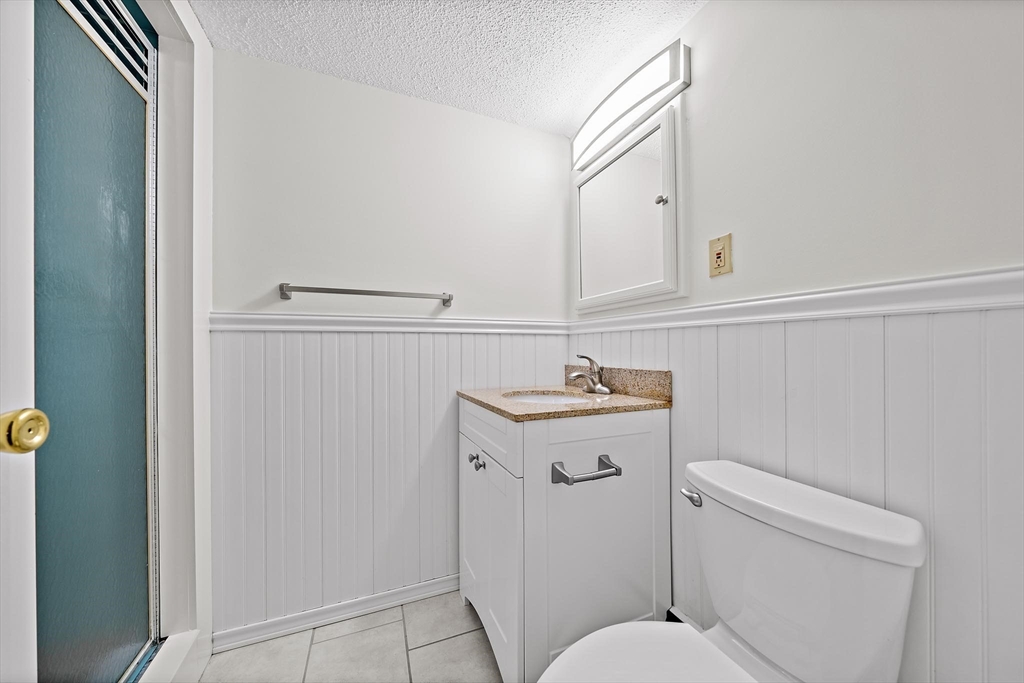 50 Green Street, Unit 108 Brookline, MA 02446 - Photo 14 of 22 a bathroom with a sink a toilet and with mirror