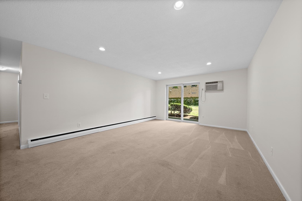 50 Green Street, Unit 108 Brookline, MA 02446 - Photo 5 of 22 a view of a livingroom with an empty space and a window