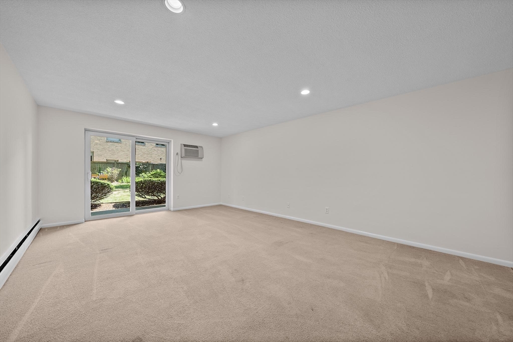 50 Green Street, Unit 108 Brookline, MA 02446 - Photo 6 of 22 an empty room with windows and outdoor view
