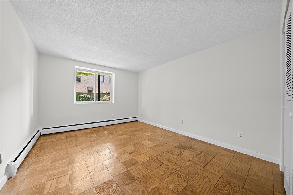 50 Green Street, Unit 108 Brookline, MA 02446 - Photo 10 of 22 an empty room with windows