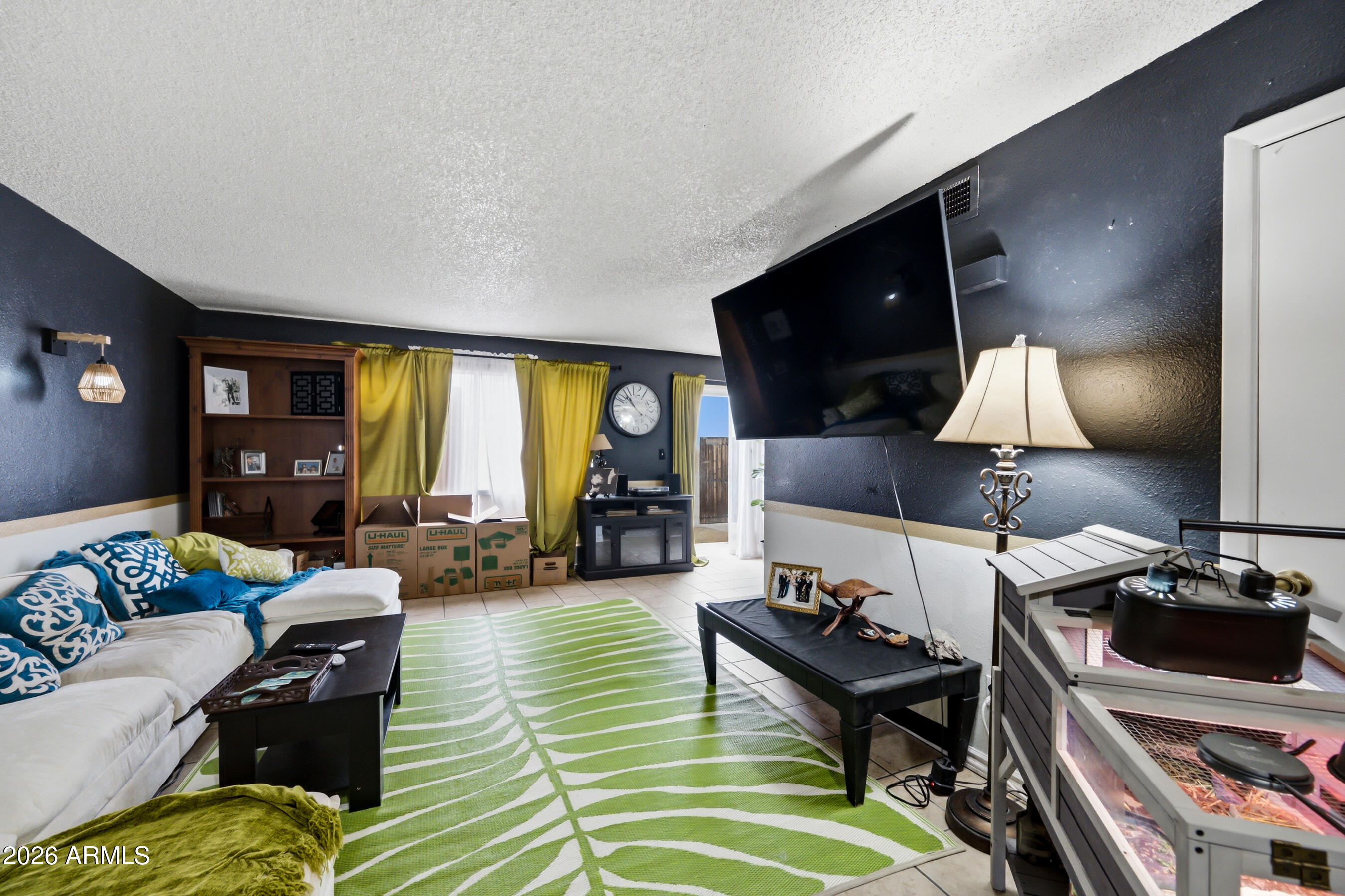 1051 South Dobson Road, Unit 187 Mesa, AZ 85202 - Photo 1 of 18 a living room with furniture and a flat screen tv