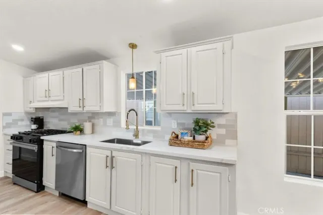 a kitchen with white cabinets and white appliances