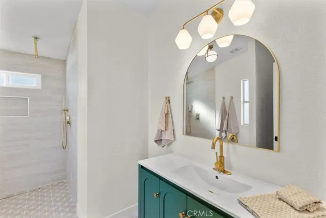 a bathroom with a sink vanity and a mirror