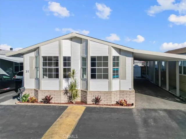a front view of a house with a sitting space