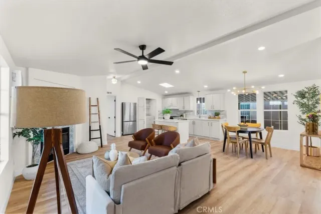 a living room with furniture and kitchen view