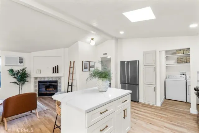 a kitchen with a refrigerator and a stove top oven