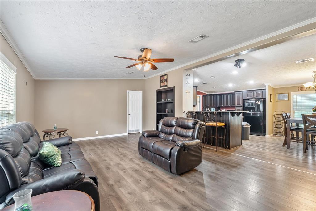 13902 East Travis Lane Log Cabin, TX 75148 - Photo 2 of 24 a living room with furniture kitchen view and a wooden floor