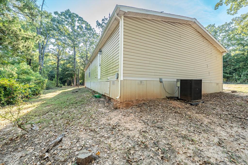 13902 East Travis Lane Log Cabin, TX 75148 - Photo 24 of 24 a view of a house with a yard and garage