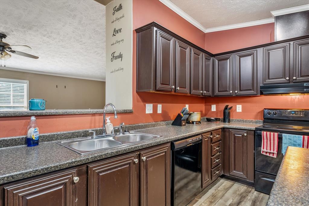 13902 East Travis Lane Log Cabin, TX 75148 - Photo 5 of 24 a kitchen with stainless steel appliances granite countertop a sink stove and cabinets