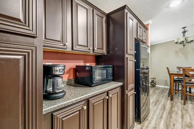 a kitchen with stainless steel appliances granite countertop a sink and a refrigerator