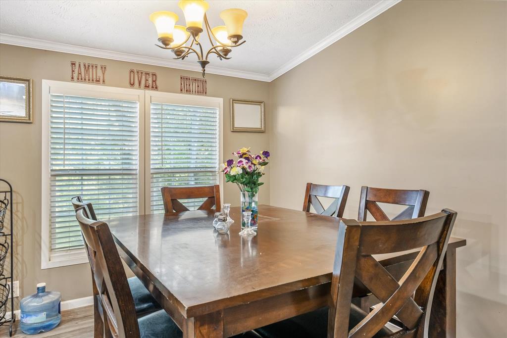 13902 East Travis Lane Log Cabin, TX 75148 - Photo 8 of 24 a view of a dining room with furniture and wooden floor
