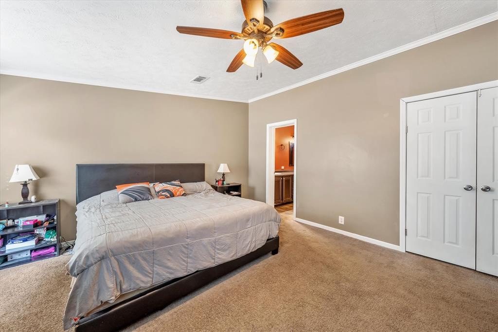 13902 East Travis Lane Log Cabin, TX 75148 - Photo 10 of 24 a bedroom with a bed and a ceiling fan