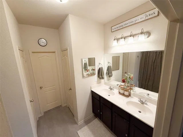a bathroom with a double vanity sink and a mirror