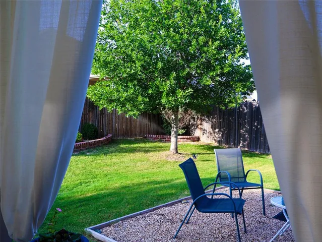 a view of an outdoor sitting area in a backyard
